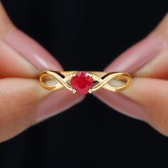 Product Details Embrace romance with this Ruby Solitaire Promise Ring, designed in an elegant and sophisticated style. The ring features a Round Cut Ruby set as a solitaire on a Gold Crossover Shank. For special occasions, this jewelry accessory is crafted in Gold Metal. Product Information SKU SHP-RINGS032210214 Width 4.6 mm Height 3.3 mm Weight 1.50 gm (Approximate) RUBY INFORMATION No.of Stones 1 Pieces Total Weight 0.65 Carat (Approximate) Dimension(approx) Round-5X5 mm-1 Pcs Color Red Cut B Engagement Ring With Ruby, Ruby Promise Ring, Ruby Ring Designs, Destined To Be Together, Aesthetic Ring, Ruby Set, Aesthetic Rings, Promise Ring For Her, Crossover Ring