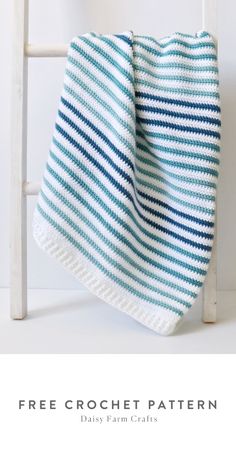 a blue and white striped blanket sitting on top of a chair