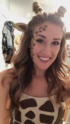 a woman with her face painted like a giraffe