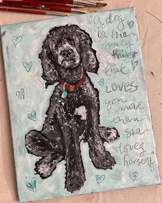 a drawing of a black dog sitting on top of a piece of paper next to colored pencils