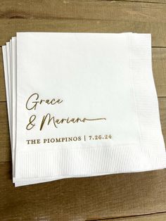 three personalized napkins with the names of two people and one is gold on them