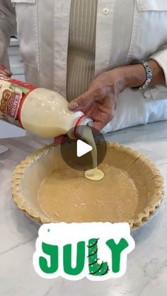 a person pouring something into a pie crust