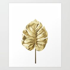 a gold leaf on a white background