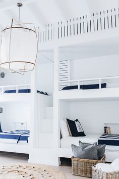 a room with bunk beds and white walls