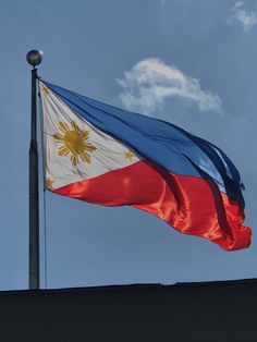 the philippines flag is flying high in the sky