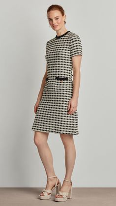 Exuding modern sophistication and classic elegance, the Lily dress features a stylish houndstooth boucle fabric, trimmed pockets, and glittering golden buttons. The effortlessly chic mid-length design is sure to turn heads in any setting, from the boardroom to the cocktail lounge - making a timelessly tasteful impression on all who behold it. Boucle Fabric Back Zipper Closure Front Pocket Buttons Chic Houndstooth Tweed Dress For Work, Chic Tweed Workwear Dresses, Fitted Tweed Dress With Houndstooth Pattern For Formal Occasions, Formal Fitted Tweed Dress With Houndstooth Pattern, Houndstooth Mini Dress For Work, Chic Houndstooth Mini Dress For Work, Black Houndstooth Tweed Dress For Work, Elegant White Houndstooth Mini Dress, Elegant White Mini Dress With Houndstooth Pattern