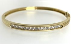 Diamond Bangle This beautiful vintage bangle bracelet is crafted from 18ct yellow gold and features 15 round diamonds with a total carat weight of 1 carat. The diamonds are white/colourless and are channel set, the bangle has a box closure and a safety catch for added security. The bracelet is hallmarked and was manufactured in 1992. This stunning bracelet is perfect for any special occasion, such as an engagement, graduation, anniversary, birthday, Valentine's Day, Mother's Day or Christmas. It Channel Set Round Bangle For Anniversary, Classic Channel Set Bangle For Anniversary, Round Channel Set Bangle For Anniversary, Classic Channel Set Round Bangle, Anniversary Channel Set Bangle, Classic Yellow Gold Bracelet With Channel Set, Classic Yellow Gold Bracelet Channel Set, Classic Yellow Gold Bracelets Channel Set, Yellow Gold Channel Set Bracelets For Wedding