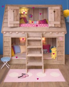 a doll house with bunk beds and stairs to the top floor is made out of wood