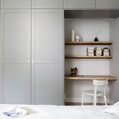 a white chair sitting in front of a book shelf