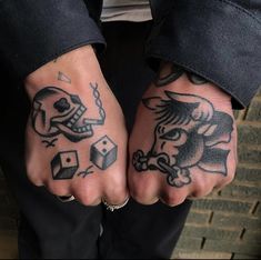 two hands with tattoos and dices on them