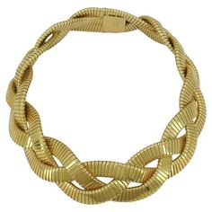 This vintage 18k gold braided tubogas choker necklace by Carlo Weingrill, circa 1980s, is a bold and luxurious piece. The necklace measures 16 inches in length and 1 inch in width, weighing an impressive 218.8 grams. The tubogas design is characterized by its flexible, coiled construction, which creates a smooth, sleek look while maintaining durability. It is stamped "ITALY," "18k," and "*15 VR," which is a known hallmark for Carlo Weingrill, a renowned Italian jeweler known for quality craftsmanship. This braided choker's substantial weight and intricate braided design make it a striking statement piece, yet also comfortable to wear. Ruby Diamond Necklace, Wire Choker Necklace, Sapphire Diamond Necklace, Vintage Choker Necklace, Choker Designs, Gold Chain Choker, Diamond Necklace Designs, Vintage Choker, Diamond Necklace Set