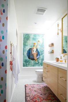 a bathroom with a painting on the wall