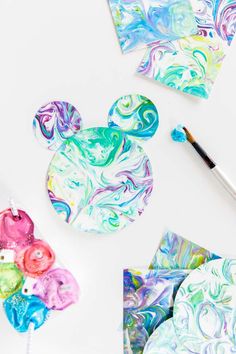 the mickey mouse head is painted with acrylic paint and then it's cut out to look like marbled paper