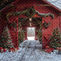 a red barn decorated with christmas trees and presents