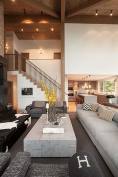 a living room filled with furniture next to a staircase