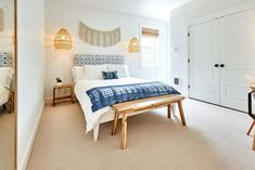 a bedroom with white walls and carpeted flooring