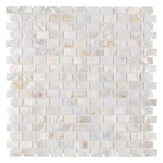 a white tile wall that is made out of mother of pearl and has an irregular pattern