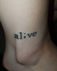 the word alive is written on someone's lower back