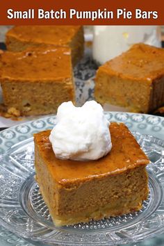 small batch pumpkin pie bars on a plate with whipped cream in the middle and one slice missing