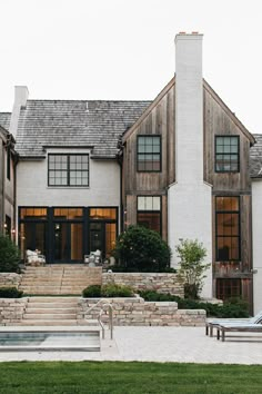 an instagram photo of a house with stairs leading up to the front door and windows