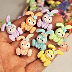 a hand is holding several small toy animals