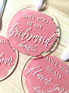 three pink coasters that say, will you be my bridesmaid?