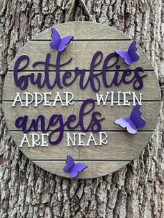 a sign that says butterflies appear when angels are near on the side of a tree