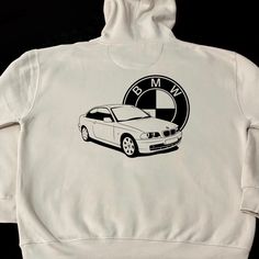 a white bmw hoodie with an emblem on it