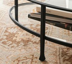 a table with two books on top of it and a coffee table in the middle