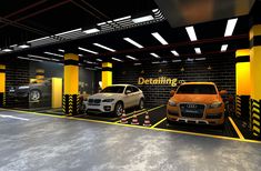 two cars are parked in an underground parking garage with yellow and black stripes on the walls