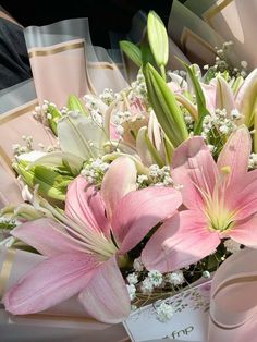 a bouquet of pink lilies and baby's breath