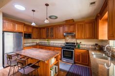 a kitchen with wooden cabinets and stainless steel appliances