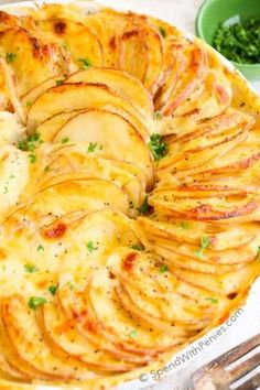 this is an image of a potato pie with text overlay that says, augratin potatoes