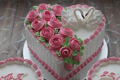 a heart shaped cake decorated with pink roses