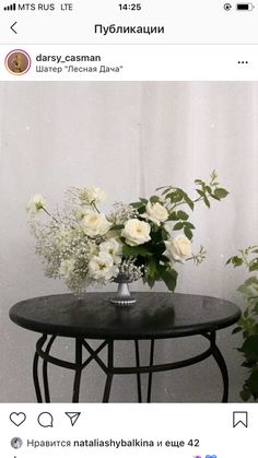 a vase with white flowers on top of a table