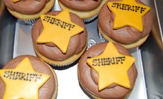 some cupcakes with yellow frosting and stars on them that are labeled sheriff