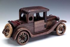 an old model car made out of wood