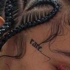 a close up of a child's face with the word love tattooed on her forehead