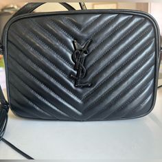 Ysl Lou Camera Bag, Black Logo, Dust Bag Included, In Great Condition. A Few Small Wear Marks Noted In Pictures Saint Laurent "Lou" Shoulder Bag In Quilted Leather Signature Tonal Ysl Logo Lettering Adjustable Shoulder Strap Zip Top Closure Exterior, Back Slip Pocket Black Hardware. Interior, One Slip Pocket Approx. 9.1"H X 6.3"W X 2.4"D Made In Italy Ysl Lou Camera Bag Black, Ysl Lou Camera Bag, Black Hardware, Quilted Leather, Black Logo, Letter Logo, Camera Bag, Yves Saint Laurent, Dust Bag