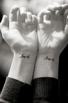 two wrist tattoos with the words love on them