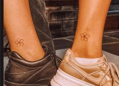 two people with matching tattoos on their legs, one has a flower tattoo on her left ankle