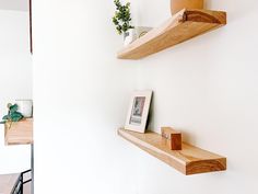 two wooden shelves on the wall above a table