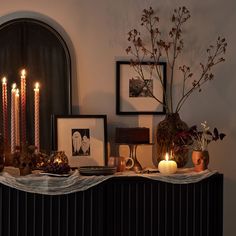 a table with candles and pictures on it