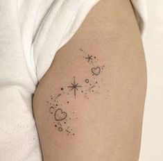 a woman's arm with stars and hearts tattoo on the left side of her body