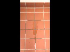 the tile in this bathroom is pink and has white grouting on it's walls