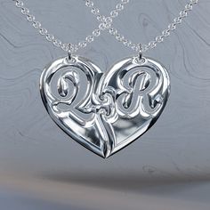 two initials in the shape of a heart on a chain