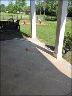 the back porch has an orange ball on it and some chairs are in the background