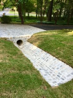 a walkway made out of bricks in the grass