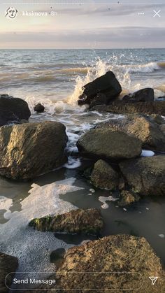 rocks on the beach with water splashing over them