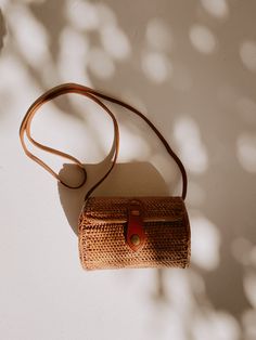 DescriptionDress it up or dress it down. This natural rattan purse may just be your new favorite accessory. Handmade in Bali, features include: circle body shape, leather strap with metal snap closure, and lined with traditional batik fabric. SizeBody: 6.25"x4.75"Strap: 22" Materials LeatherRattanBrass Circle Body Shape, Rattan Purse, Rattan Handbags, Sustainable Accessories, Retro Handbags, Summer Purses, Retro Bags, Batik Fabric, Body Shape